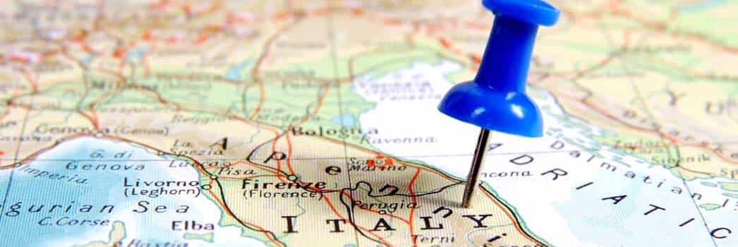Destination Italy Blue pin stuck in Italy map
